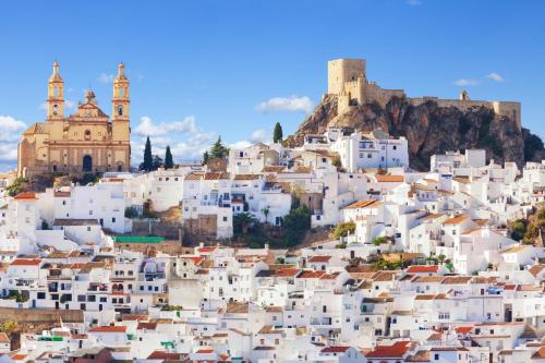 a view of a white village on a hill with buildings at Crisol Chiclana in Chiclana de la Frontera