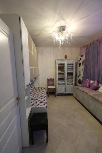 a living room with a couch and a chandelier at Rapallo La Vista by PortofinoVacanze in Rapallo