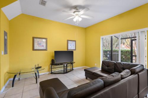 a living room with a couch and a tv at SHVCK5 - Coral Cay Resort #5 - 4 Bed 3 Baths Townhome in Kissimmee
