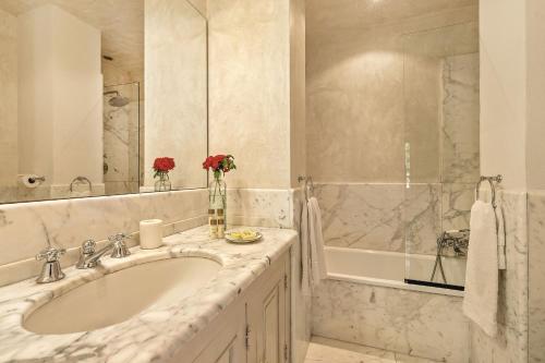 a white bathroom with a sink and a tub at Centolivi 8 by Salogi Villas in Montecastello