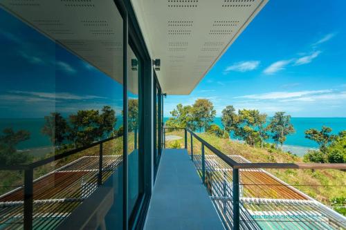a view of the ocean from the balcony of a house at Tahiana Villa in Haad Tian
