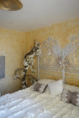 a large white bed in a bedroom with a wall at Rapallo La Vista by PortofinoVacanze in Rapallo