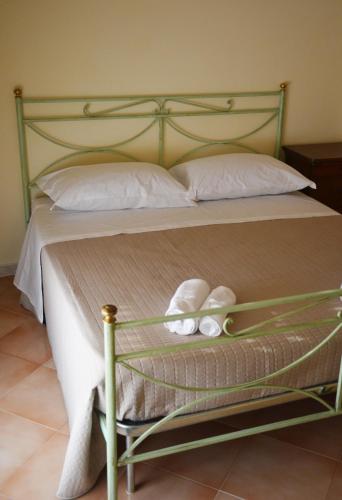 a bed with two white towels sitting on it at Casa Alfieri in Paestum