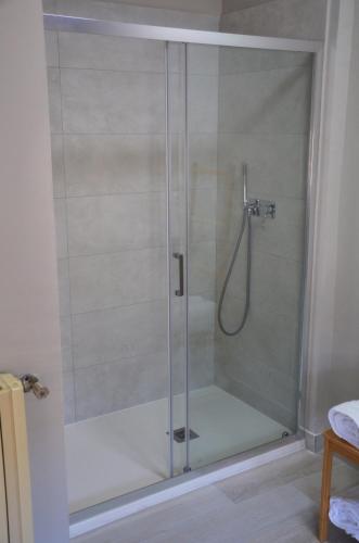 a shower with a glass door in a bathroom at Casa Alfieri in Paestum