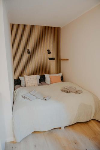 a bedroom with a large bed with two towels on it at sleepArt hygge in Celle