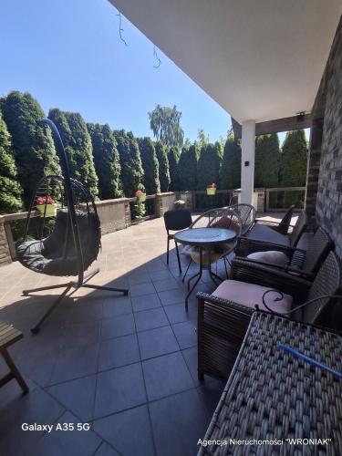 a patio with chairs and a table on a patio at Sunny Hill Apartment in Smętowo Chmieleńskie