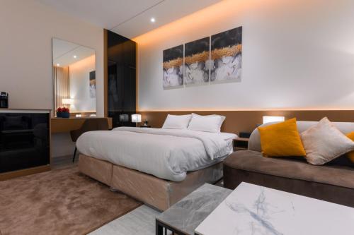 a hotel room with a bed and a couch at Riyadh Luxury in Riyadh