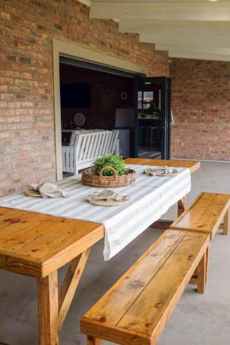 a picnic table with two benches on a patio at High Tide 12 sleeper in Agulhas