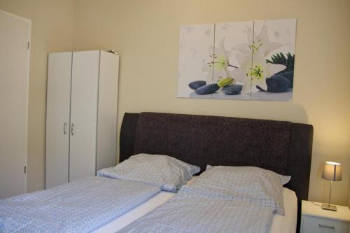 Postel nebo postele na pokoji v ubytování Inselblume 48 - Kuschlige Ferienwohnung in der Strandburg