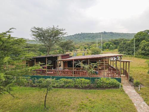 a house in the middle of a field at Castel Mara Camp in Masai Mara