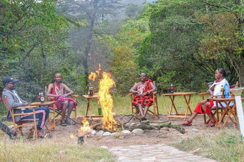 a group of people sitting around a camp fire at Castel Mara Camp in Masai Mara
