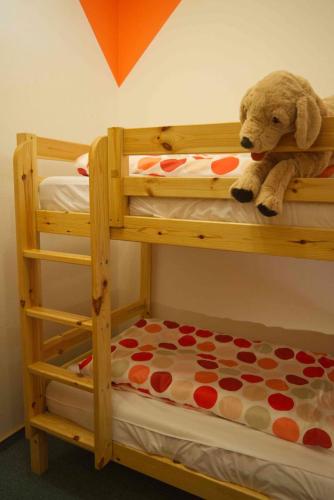 a teddy bear sitting on top of a bunk bed at Inselblume 02 - Maritime Ferienwohnung, Blick zum Yachthafen in Burgtiefe auf Fehmarn 