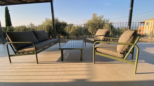 two chairs and a table on a patio at Spitaki Among Olives in Tsoukalades
