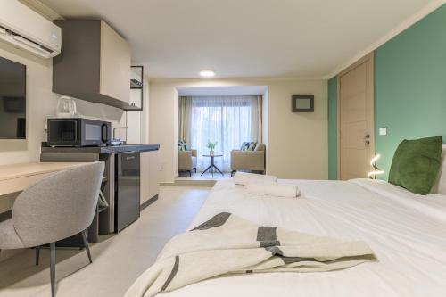 a bedroom with a bed and a desk with a microwave at CityZen - Boutique Studios in Achrafieh in Beirut