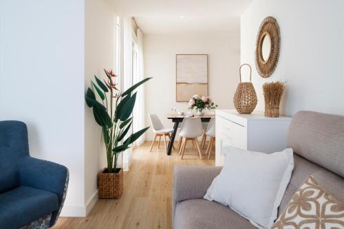 a living room with a couch and a table at Magno Apartments Altozano II in Seville