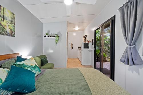 a bedroom with a large bed with blue pillows at Cabin By The Creek Hidden Oasis 