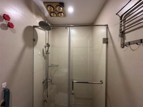 a shower with a glass door in a bathroom at An Lạc 402MD in Hanoi