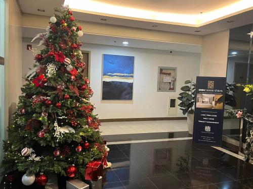 a christmas tree in a mall with a christmas decoration at Brittany Bliss Staycations at SMDC HOPE RESIDENCES in Trece Martires