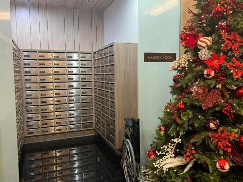 a christmas tree in a room with a bike at Brittany Bliss Staycations at SMDC HOPE RESIDENCES in Trece Martires