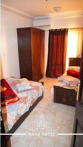 a bedroom with two beds in a room at Hana Hotel in Madinat Al Ashir min Ramadan