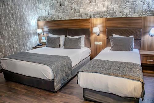 Postel nebo postele na pokoji v ubytování Ma City Hotel