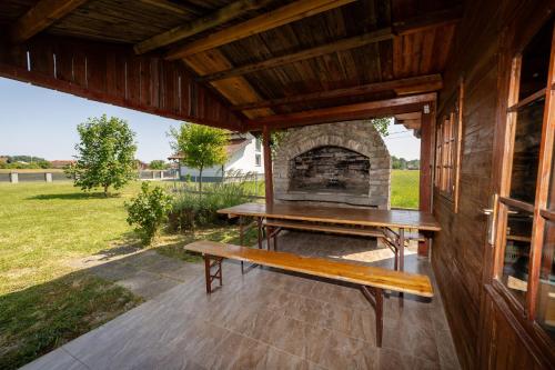 a porch with a bench and a fireplace at Three-Bedroom Holiday Home Vida with Private Pool in Zagreb