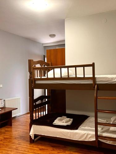 two bunk beds in a room with a table at Nana's Mini Hotel in Tbilisi City