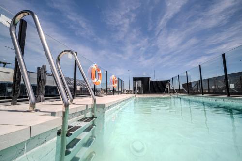 a swimming pool with metal bars on a building at ITC Madrid by Soho Boutique in Madrid