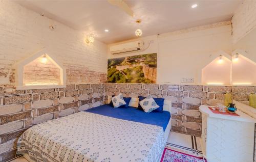 a bedroom with a bed in a brick wall at Travellers Village-City Center Hertige Home in Jaipur