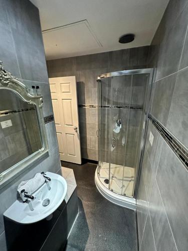 a bathroom with a glass shower and a sink at White Star Line Hotel in Liverpool