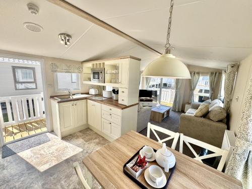 a kitchen and living room with a table and a couch at North Bay Leisure Park in Bridlington