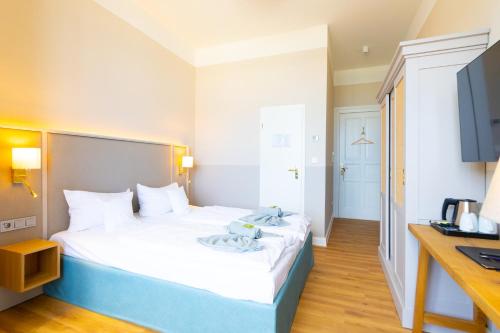 Ένα ή περισσότερα κρεβάτια σε δωμάτιο στο Hotel Germania
