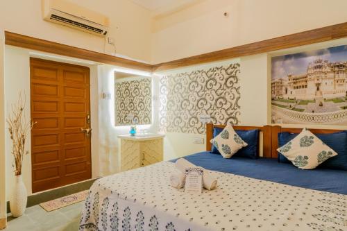 a bedroom with a bed and a large window at Travellers Village-City Center Hertige Home in Jaipur