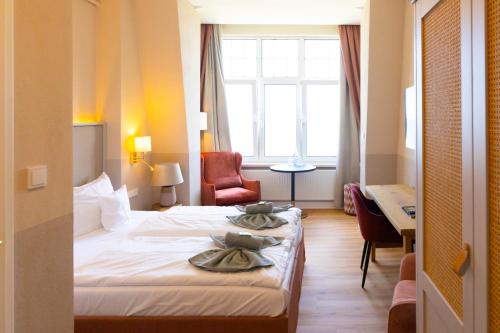 Ένα ή περισσότερα κρεβάτια σε δωμάτιο στο Hotel Germania