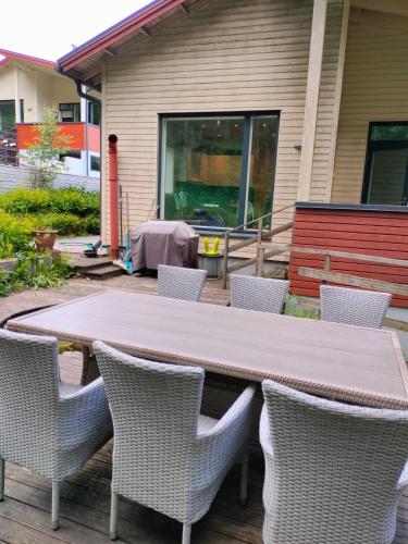 a wooden table and chairs with a table and a table and chairs at 2-3 room apartment & terrace & balcon in Espoo