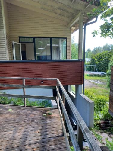 a house with a wooden porch with a wooden deck at 2-3 room apartment & terrace & balcon in Espoo