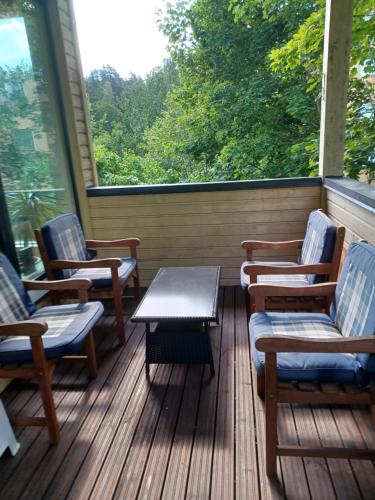 a porch with chairs and a table and a window at 2-3 room apartment & terrace & balcon in Espoo