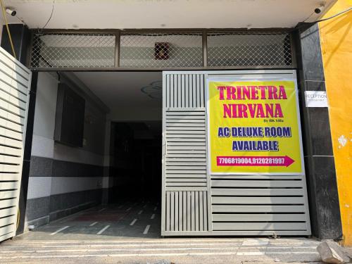 a entrance to a building with a sign on the door at Trinetra Nirvana in Varanasi