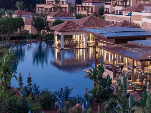 an image of a swimming pool at a resort at Grecotel LUXME Kos in Kos Town