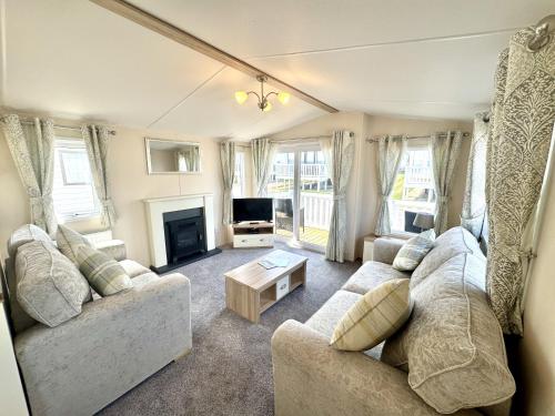 a living room with two couches and a tv at North Bay Leisure Park in Bridlington
