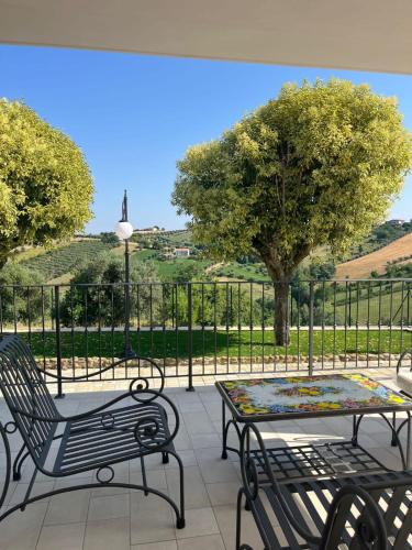 a patio with two chairs and a table with a view at Dimora i Mandorli 1 in Colonnella