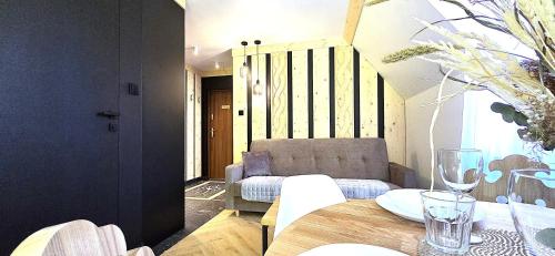a living room with a table and a couch at VIP Apartamenty Centrum2 in Zakopane