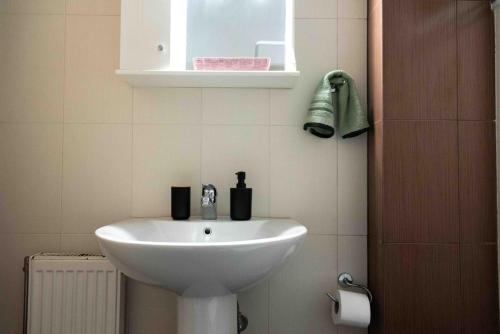 a white sink in a bathroom with a window at Sparta View Apartments Armonias Boutique B2 in Sparti
