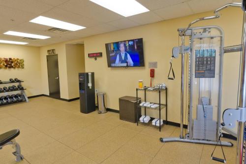 a room with a gym with a tv on the wall at Courtyard Salt Lake City Layton in Layton
