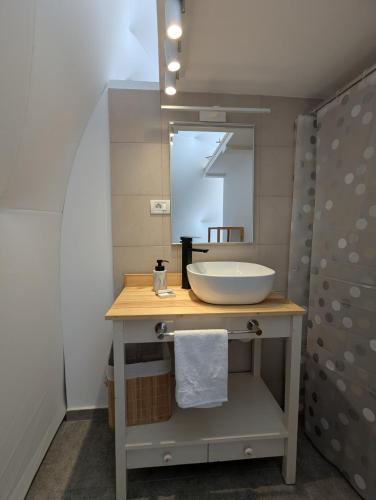 a bathroom with a sink and a mirror at Glamping Ceahlau in Durău