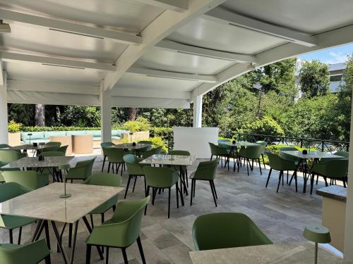 an outdoor dining area with tables and chairs at Hotel Villa Maria Regina in Rome