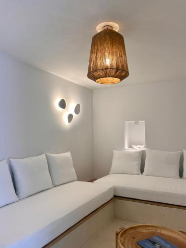 a living room with a couch and a light fixture at Entice Residence in Kóstos