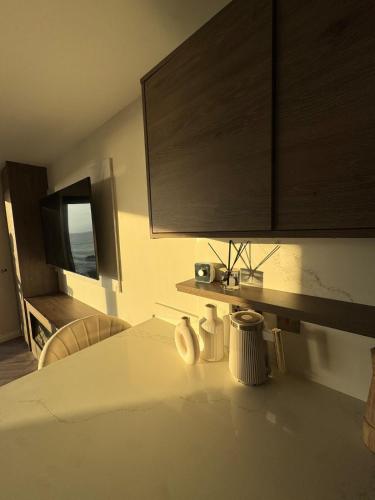 a kitchen with a white counter top with a cabinet at Sapphire Shores- Spacious 2-Bedroom Apartment with Balcony & Sea View in Portstewart