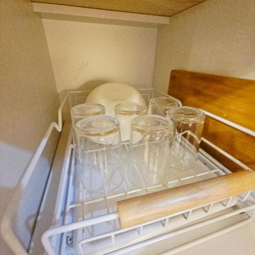 a refrigerator filled with empty glasses and a plate at Lumiére Soleia 1BR Sunset View Up to 6 Guests in Butuan