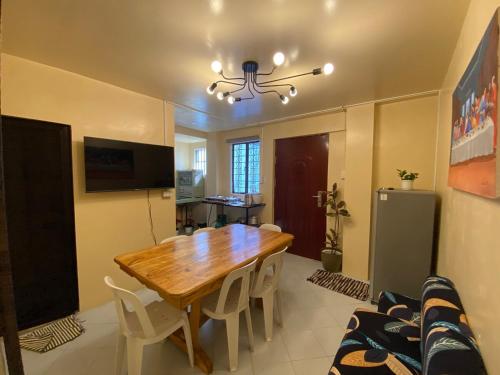 a dining room with a wooden table and chairs at Newlives Transient 2 Hillside - 1st Floor in Baguio